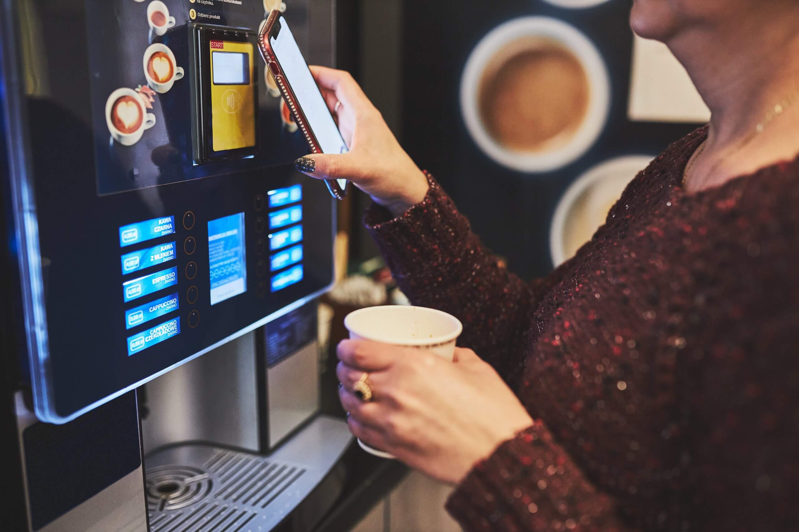 a lady paying for her order at a self-order kiosk
