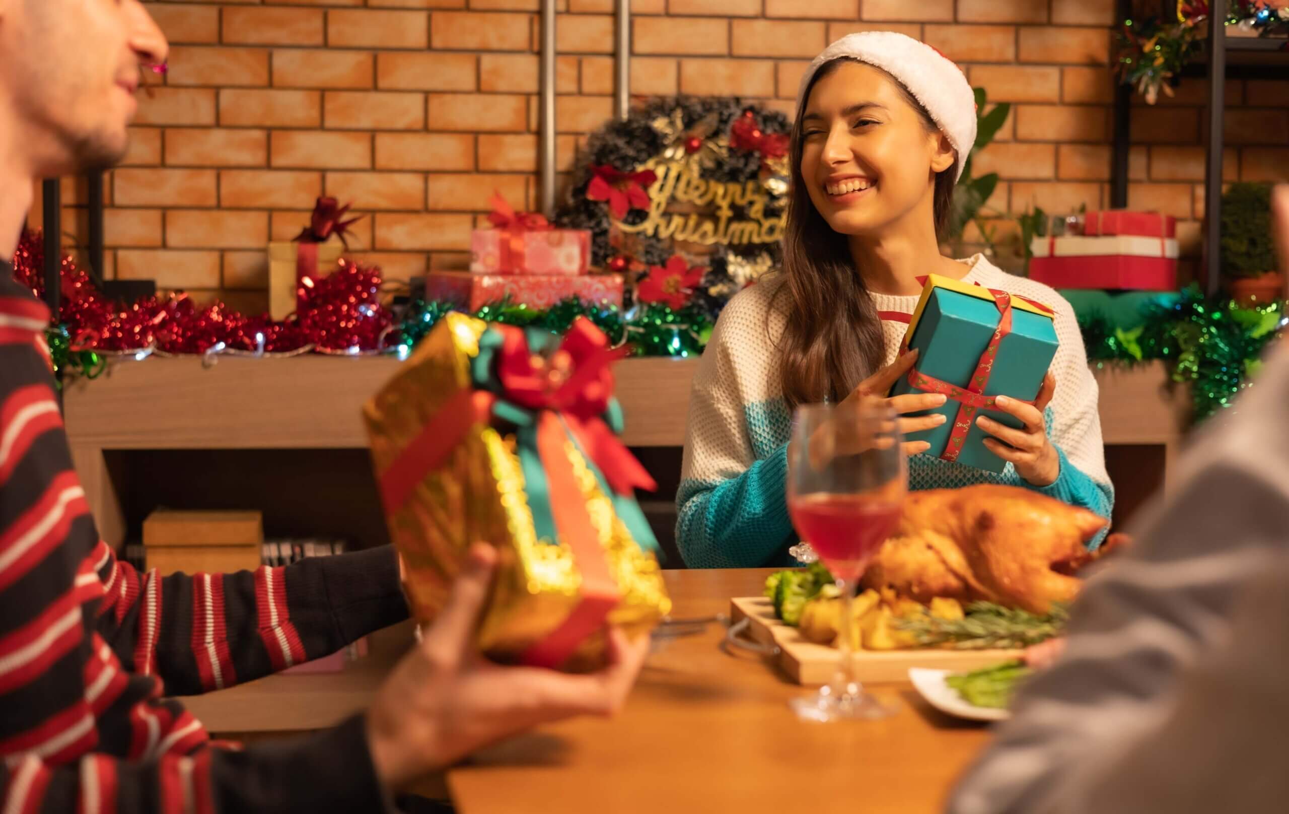 Happy loyal customers receiving gift boxes from the restaurant