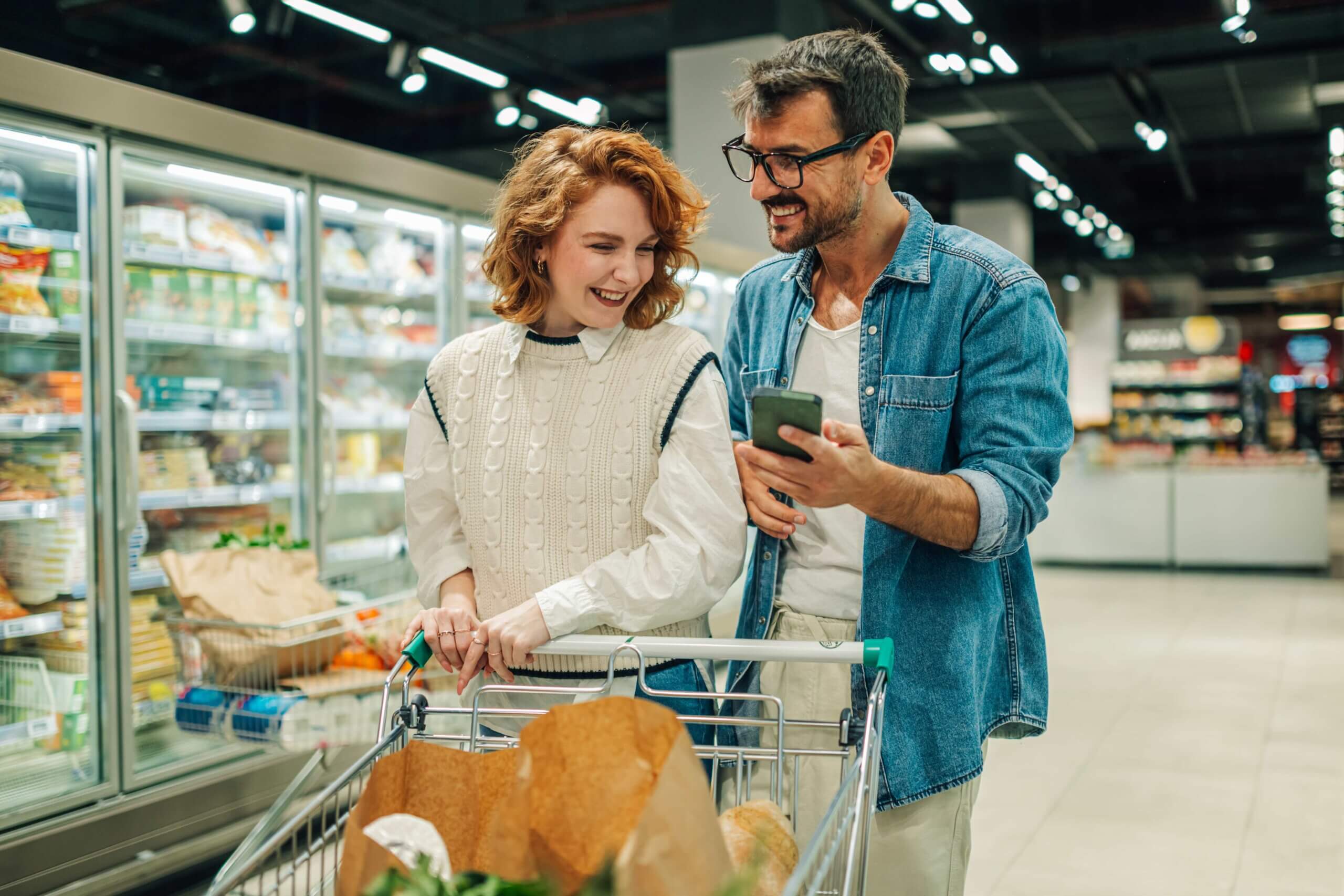 happy couple shopping in a grocery store