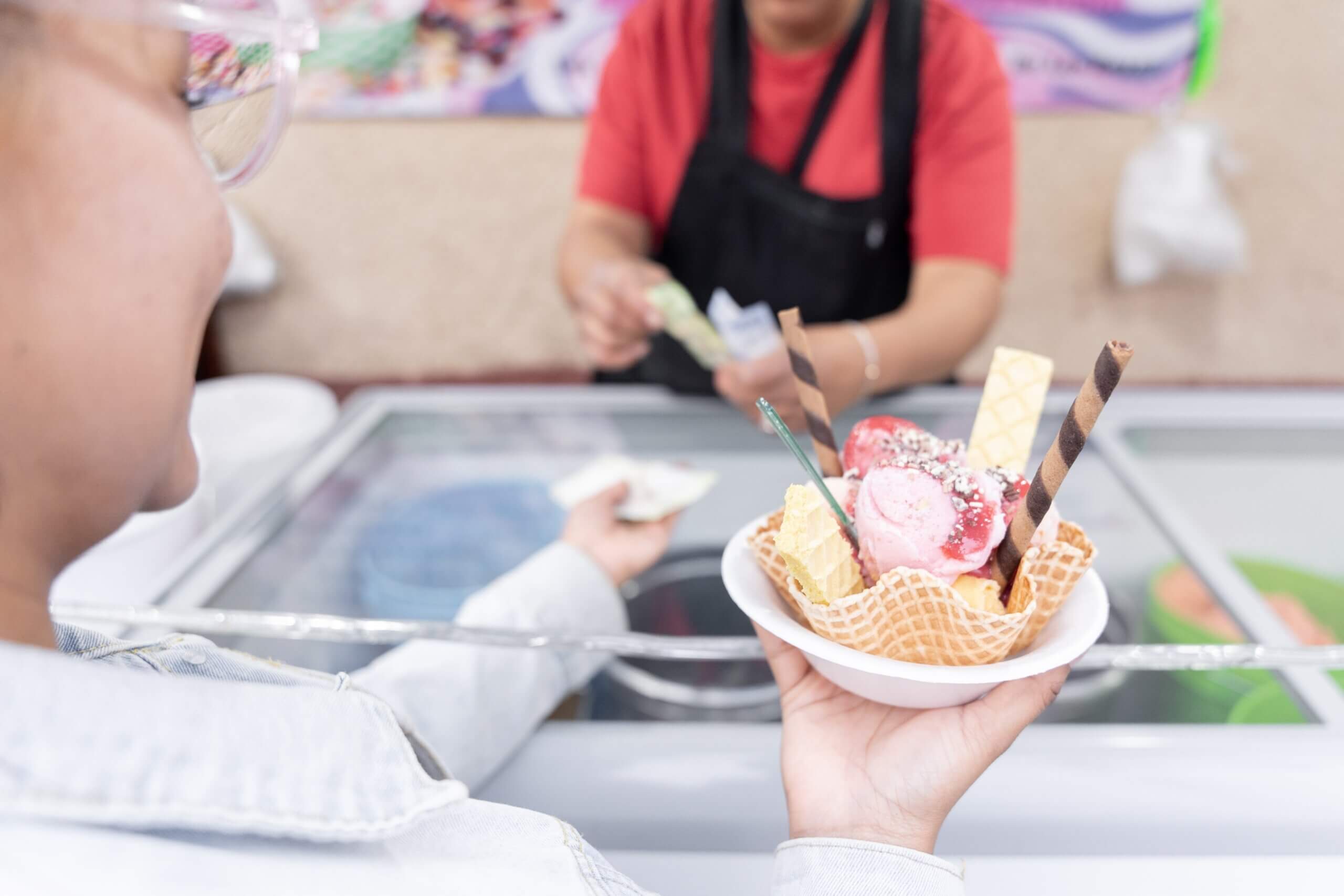 happy customer with a bowl of ice cream in a ice cream truck
