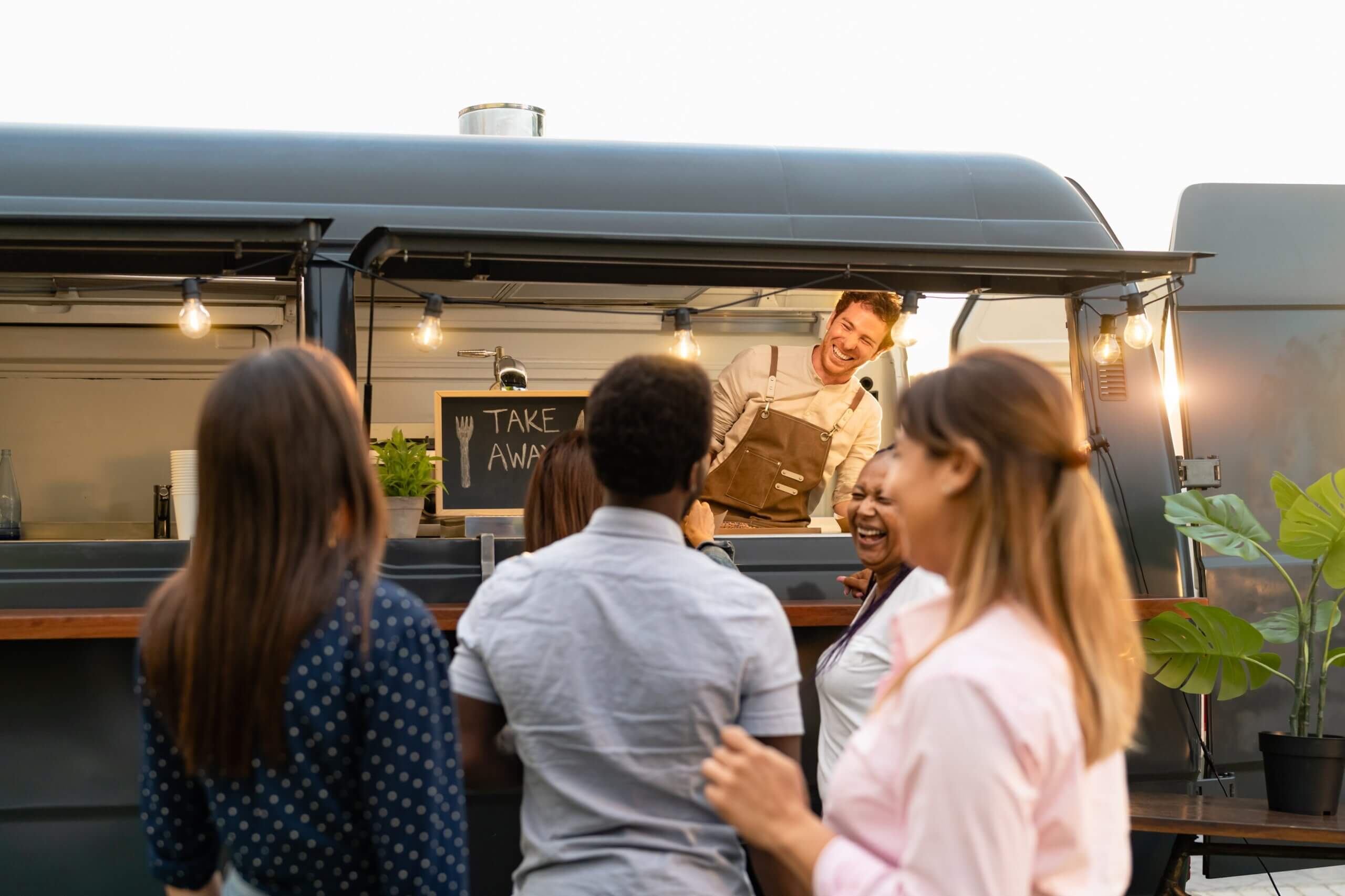customers-chatting-with-food-truck-owner-happily