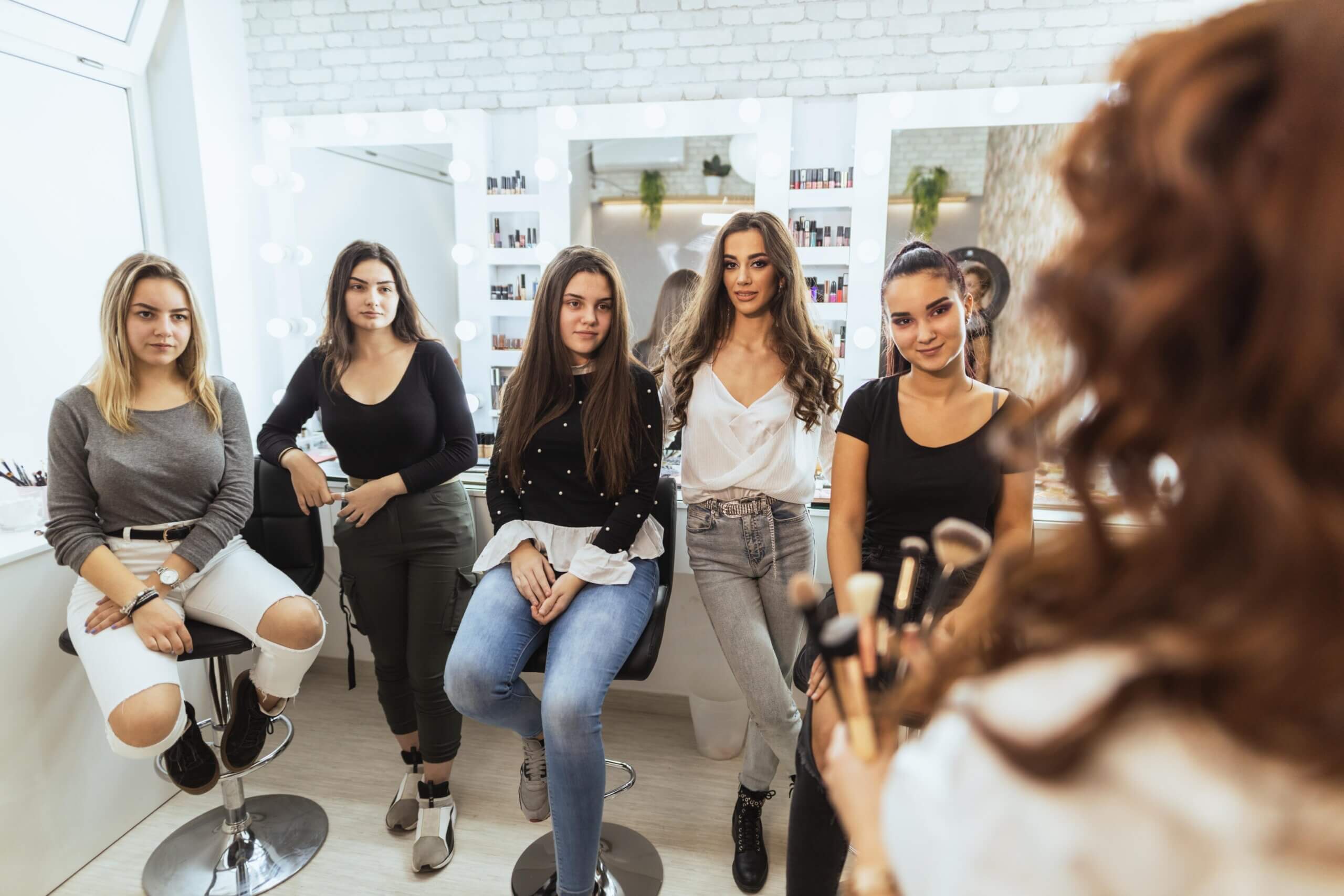 A group of female employees receiving training in a salon