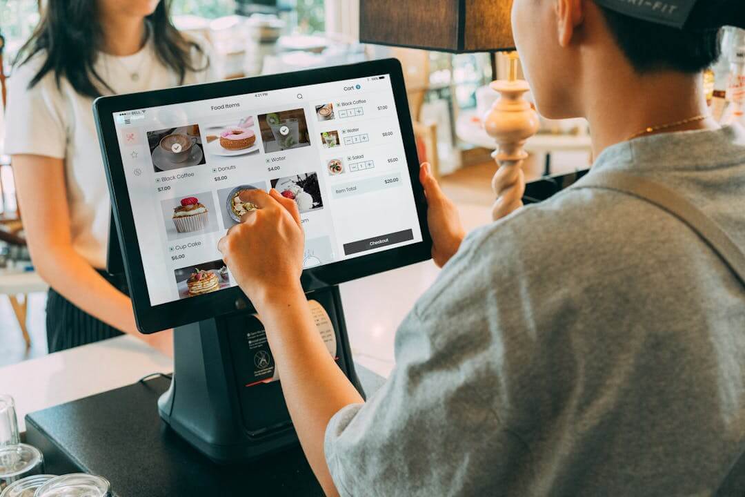 Picture shows a cashier is working on a POS system indicating the benefits of becoming a POS reseller